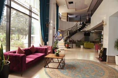 لابی هتل لیدو رامسر با پنجره های بلند و پلکان مارپیچ